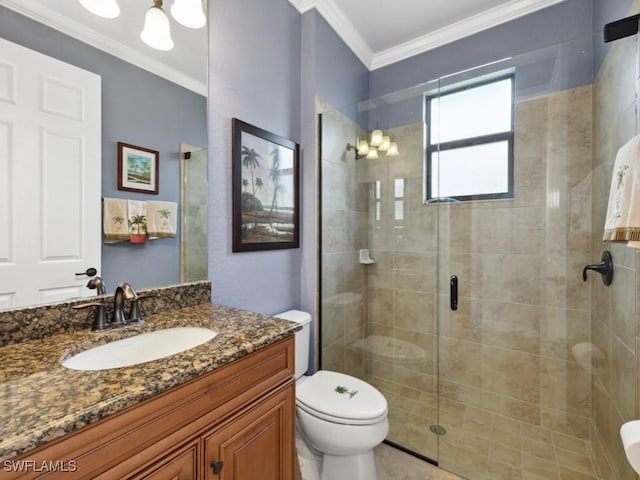 bathroom with vanity, crown molding, toilet, and a shower stall