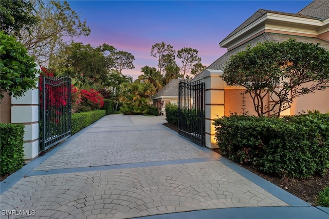 13488 Rosewood Ln, Naples, FL 34119 - view of gate at dusk