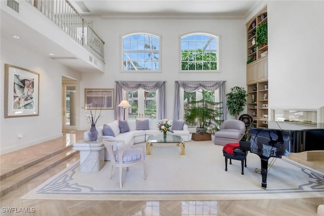 13488 Rosewood Ln, Naples, FL 34119 - living room featuring a high ceiling, baseboards, and ornamental molding