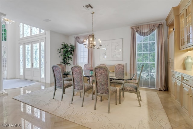 13488 Rosewood Ln, Naples, FL 34119 - dining area with healthy amount of natural light and a chandelier