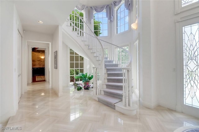 13488 Rosewood Ln, Naples, FL 34119 - foyer with stairs, baseboards, a high ceiling, and recessed lighting