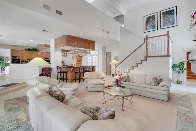 13488 Rosewood Ln, Naples, FL 34119 - living area with stairway, light tile patterned floors, a towering ceiling, and recessed lighting