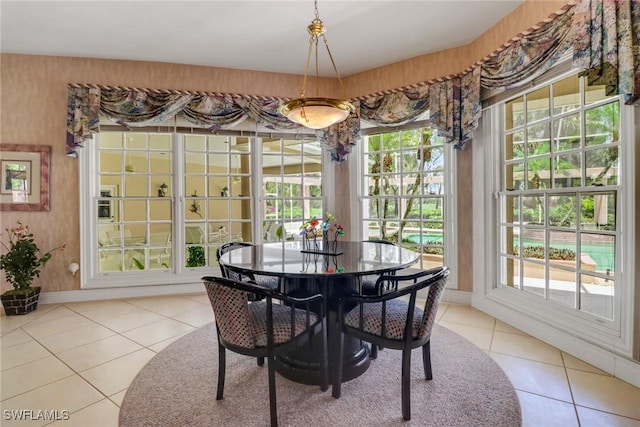 13488 Rosewood Ln, Naples, FL 34119 - dining area with tile patterned flooring and baseboards
