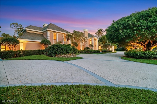 13488 Rosewood Ln, Naples, FL 34119 - view of front of property with curved driveway and stucco siding