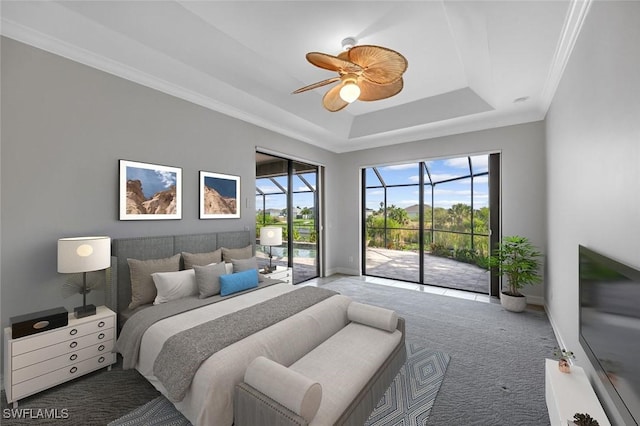 carpeted bedroom with access to outside, baseboards, a tray ceiling, a ceiling fan, and crown molding