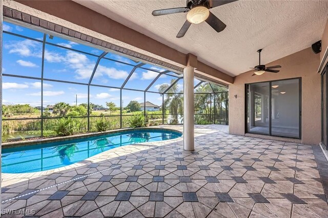 outdoor pool with ceiling fan, a patio, and a lanai