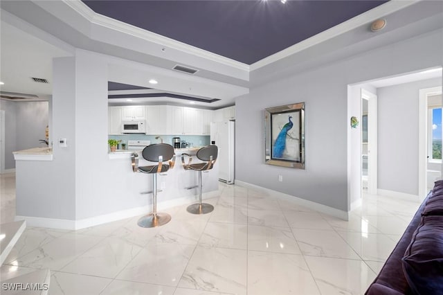 interior space featuring baseboards, white appliances, crown molding, and visible vents