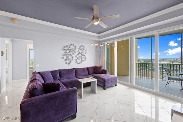 living room with crown molding, baseboards, a ceiling fan, and a raised ceiling