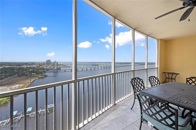 sunroom / solarium featuring a water view