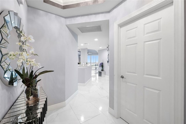 hall featuring marble finish floor and baseboards