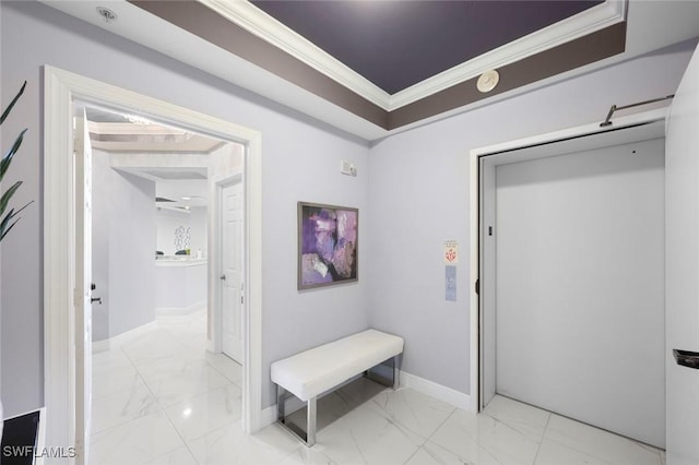 hallway with marble finish floor, baseboards, and ornamental molding