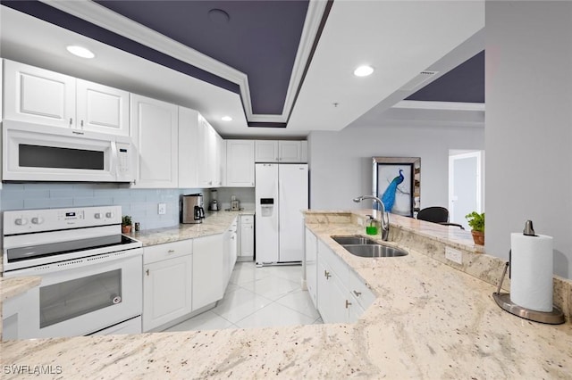 kitchen featuring a sink, light stone countertops, white appliances, and recessed lighting