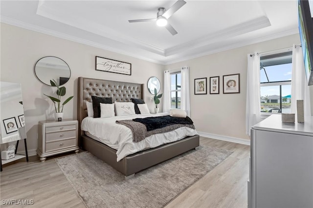 28140 Captiva Shell Loop, Bonita Springs, FL 34135 - bedroom with a tray ceiling, ceiling fan, ornamental molding, and light wood-type flooring