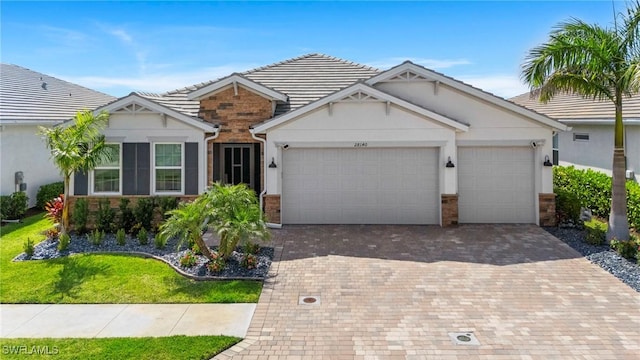 28140 Captiva Shell Loop, Bonita Springs, FL 34135 - single story home featuring stone siding, a garage, stucco siding, and decorative driveway