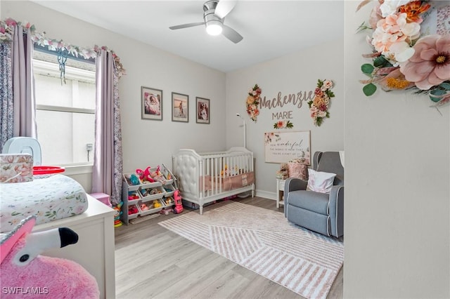 28140 Captiva Shell Loop, Bonita Springs, FL 34135 - bedroom featuring a nursery area, light wood-type flooring, and a ceiling fan