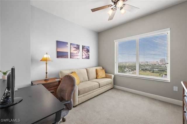 carpeted office featuring ceiling fan and baseboards