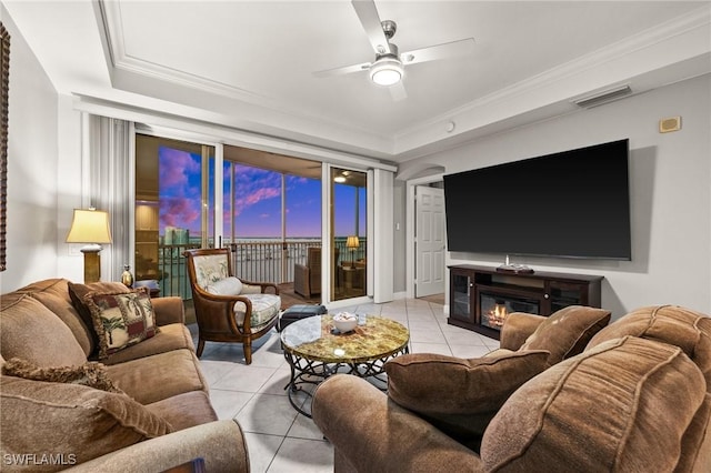 living area featuring crown molding, a ceiling fan, light tile patterned floors, and visible vents