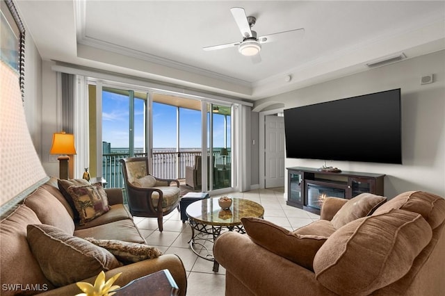living room featuring crown molding, light tile patterned floors, visible vents, and ceiling fan