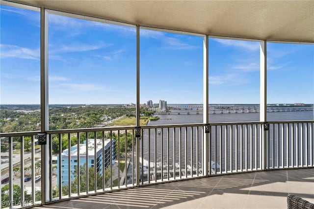 unfurnished sunroom featuring a water view