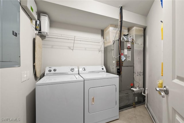 laundry room featuring washer and clothes dryer, laundry area, electric panel, and light tile patterned flooring