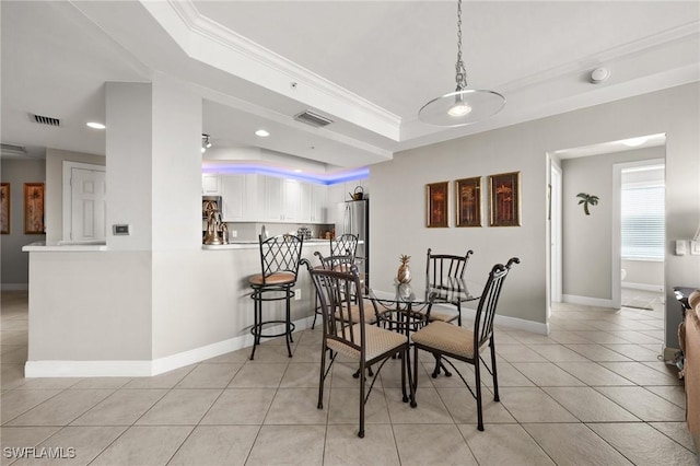 dining space with a tray ceiling, crown molding, visible vents, and recessed lighting
