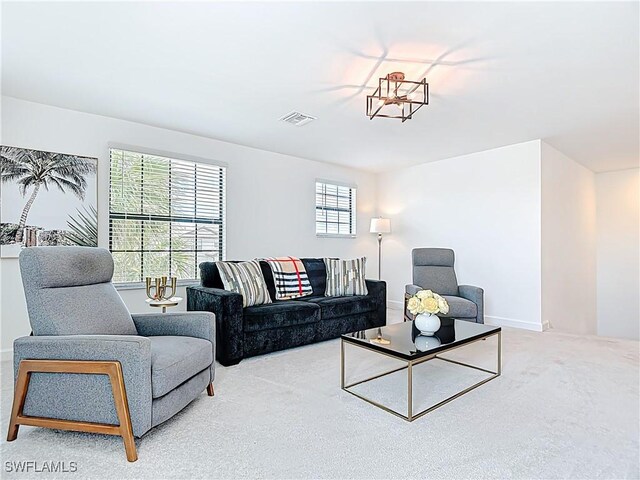 carpeted living area with visible vents and baseboards