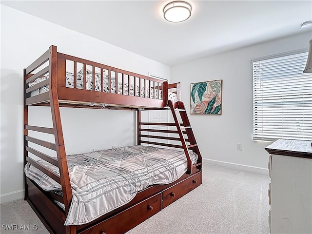 bedroom featuring baseboards and carpet