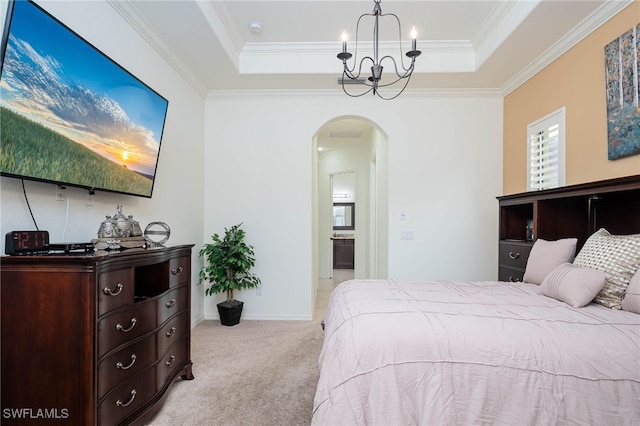 bedroom with a tray ceiling, a notable chandelier, carpet floors, crown molding, and arched walkways