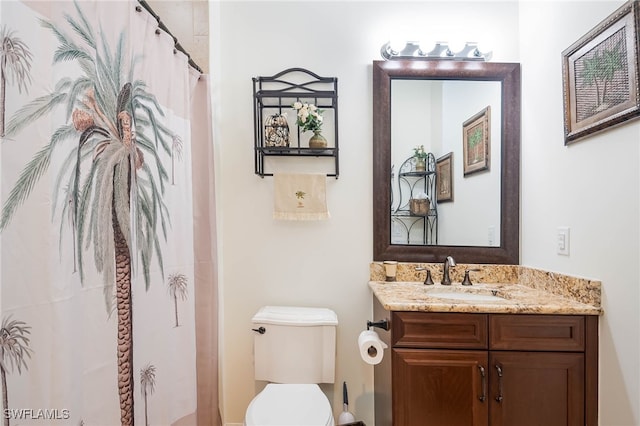 full bath featuring toilet, vanity, and a shower with shower curtain