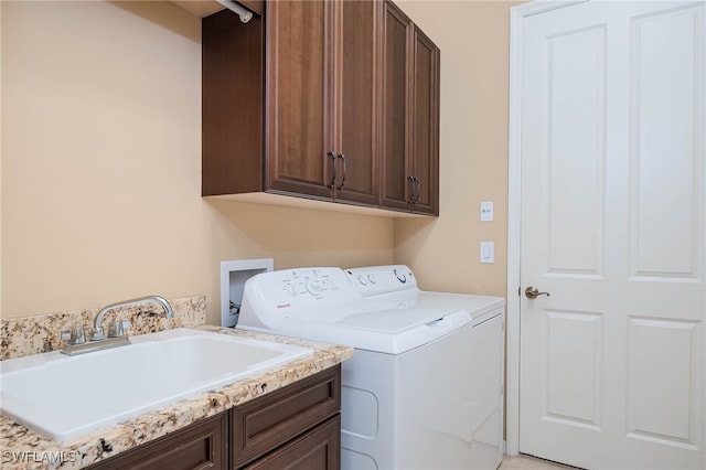 washroom featuring a sink, cabinet space, and washer and dryer