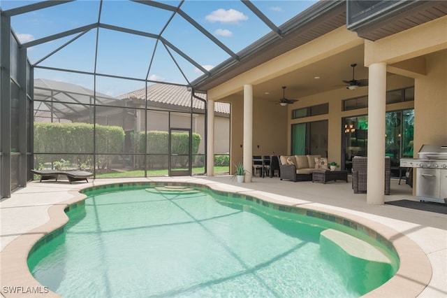 pool with a patio area, glass enclosure, grilling area, a ceiling fan, and outdoor lounge area