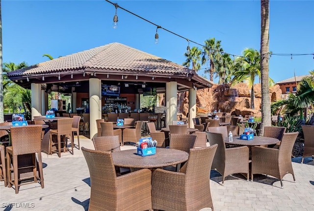view of patio featuring a gazebo and outdoor dining area