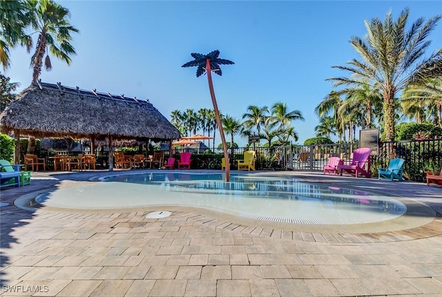 community pool featuring a gazebo, fence, and a patio area