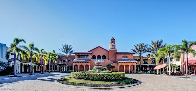 view of building exterior with curved driveway