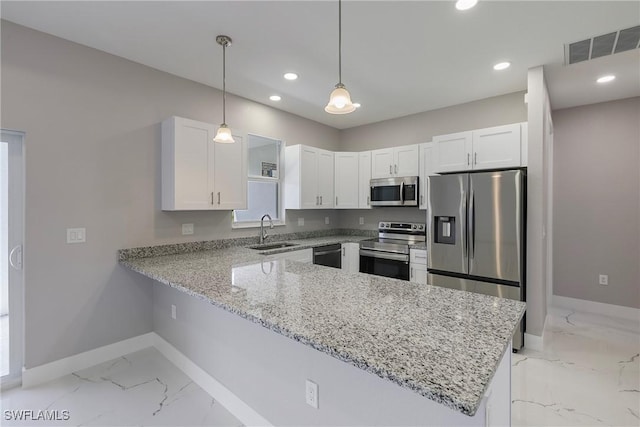 kitchen with marble finish floor, a peninsula, baseboards, a sink, and appliances with stainless steel finishes