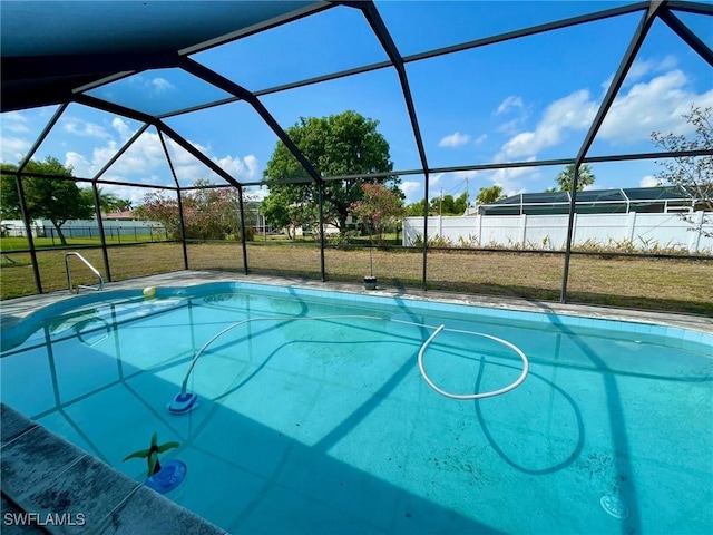 pool featuring a lanai and a lawn