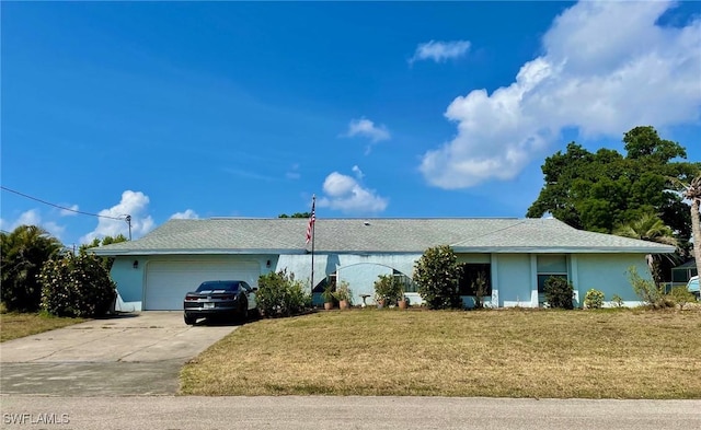 view of front of property with a front lawn, stucco siding, driveway, and a garage