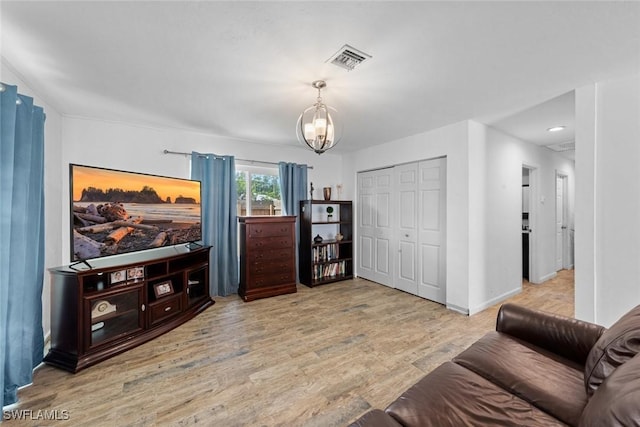2080 39th St SW, Naples, FL 34117 - living area featuring a chandelier, wood finished floors, and baseboards