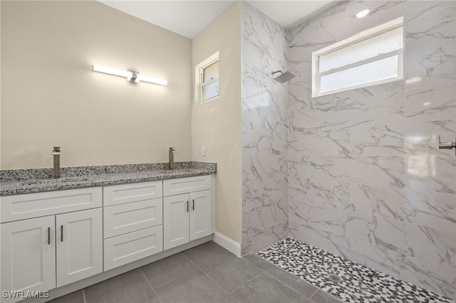 1043 Albert Ave, Lehigh Acres, FL 33971 - bathroom with a sink, a marble finish shower, baseboards, and double vanity