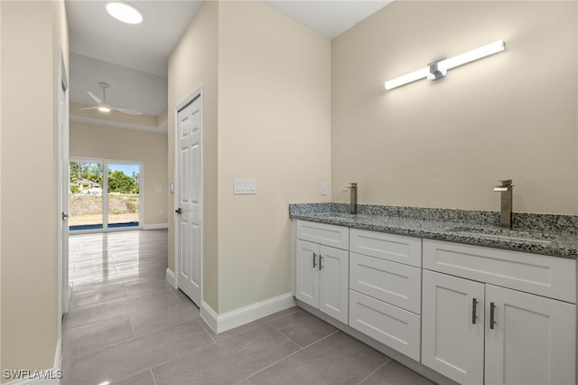1043 Albert Ave, Lehigh Acres, FL 33971 - bathroom featuring a sink, double vanity, tile patterned floors, a ceiling fan, and baseboards