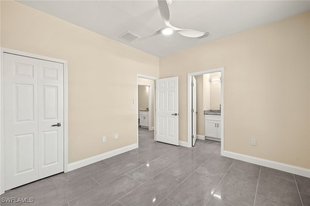 1043 Albert Ave, Lehigh Acres, FL 33971 - unfurnished bedroom with ceiling fan, baseboards, visible vents, and ensuite bathroom