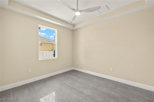 1043 Albert Ave, Lehigh Acres, FL 33971 - spare room featuring visible vents, baseboards, ceiling fan, and dark tile patterned floors