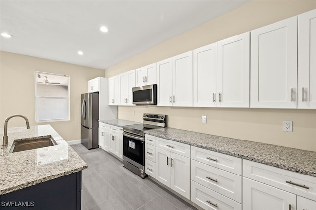 1043 Albert Ave, Lehigh Acres, FL 33971 - kitchen featuring white cabinets, recessed lighting, appliances with stainless steel finishes, and a sink