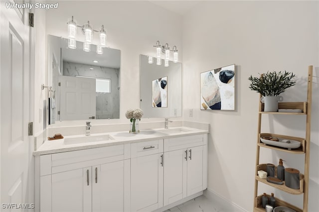 full bathroom with baseboards, a sink, a marble finish shower, and marble finish floor