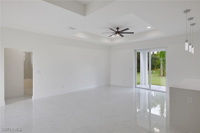spare room featuring visible vents, marble finish floor, ceiling fan, recessed lighting, and a raised ceiling