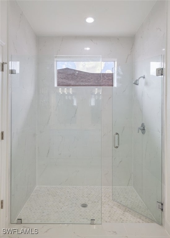 full bathroom featuring recessed lighting and a marble finish shower