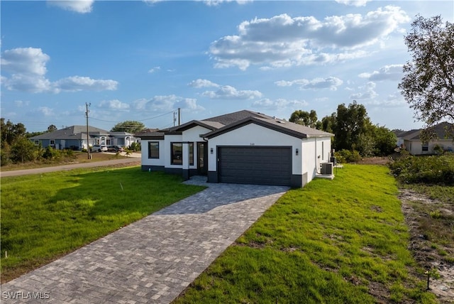 view of front of home with an attached garage, a front lawn, stucco siding, and driveway