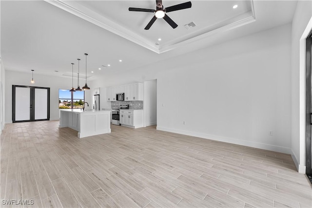 unfurnished living room featuring ceiling fan, visible vents, french doors, and light wood-style floors