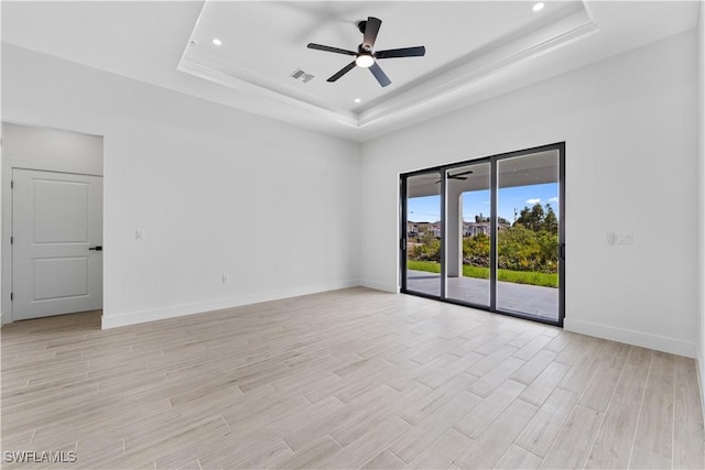 unfurnished room featuring visible vents, baseboards, recessed lighting, a raised ceiling, and a ceiling fan
