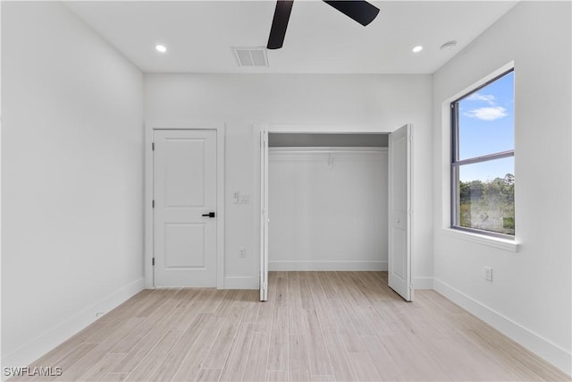 unfurnished bedroom with visible vents, a closet, light wood-style floors, baseboards, and ceiling fan
